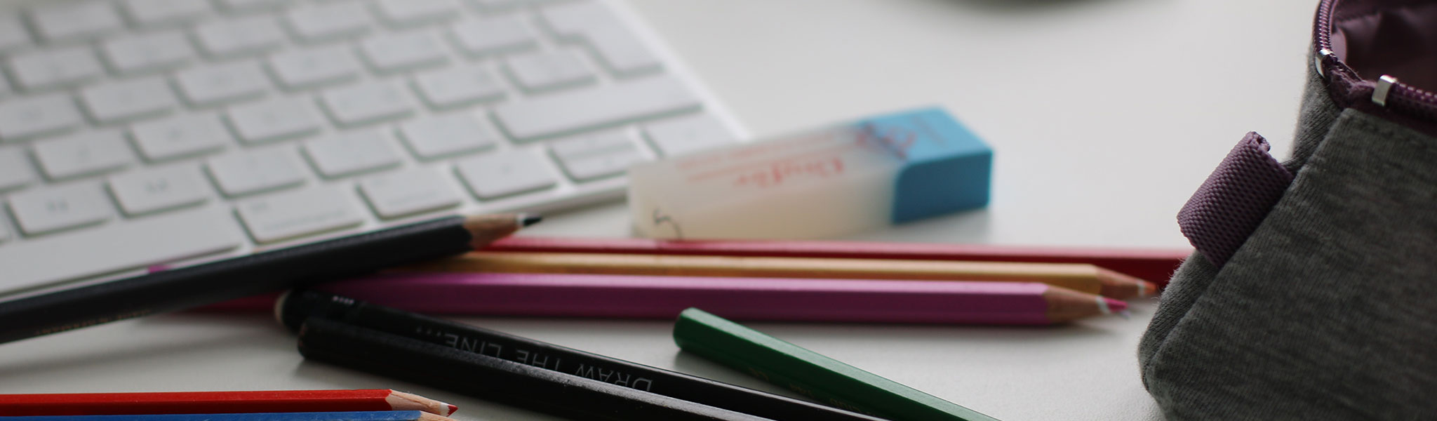 Pencils and eraser near computer keyboard